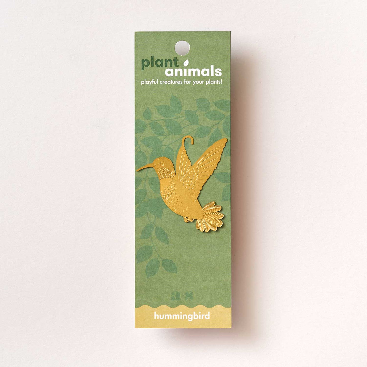 A gold-colored metal hummingbird decoration by Another Studio for Heart Gallery