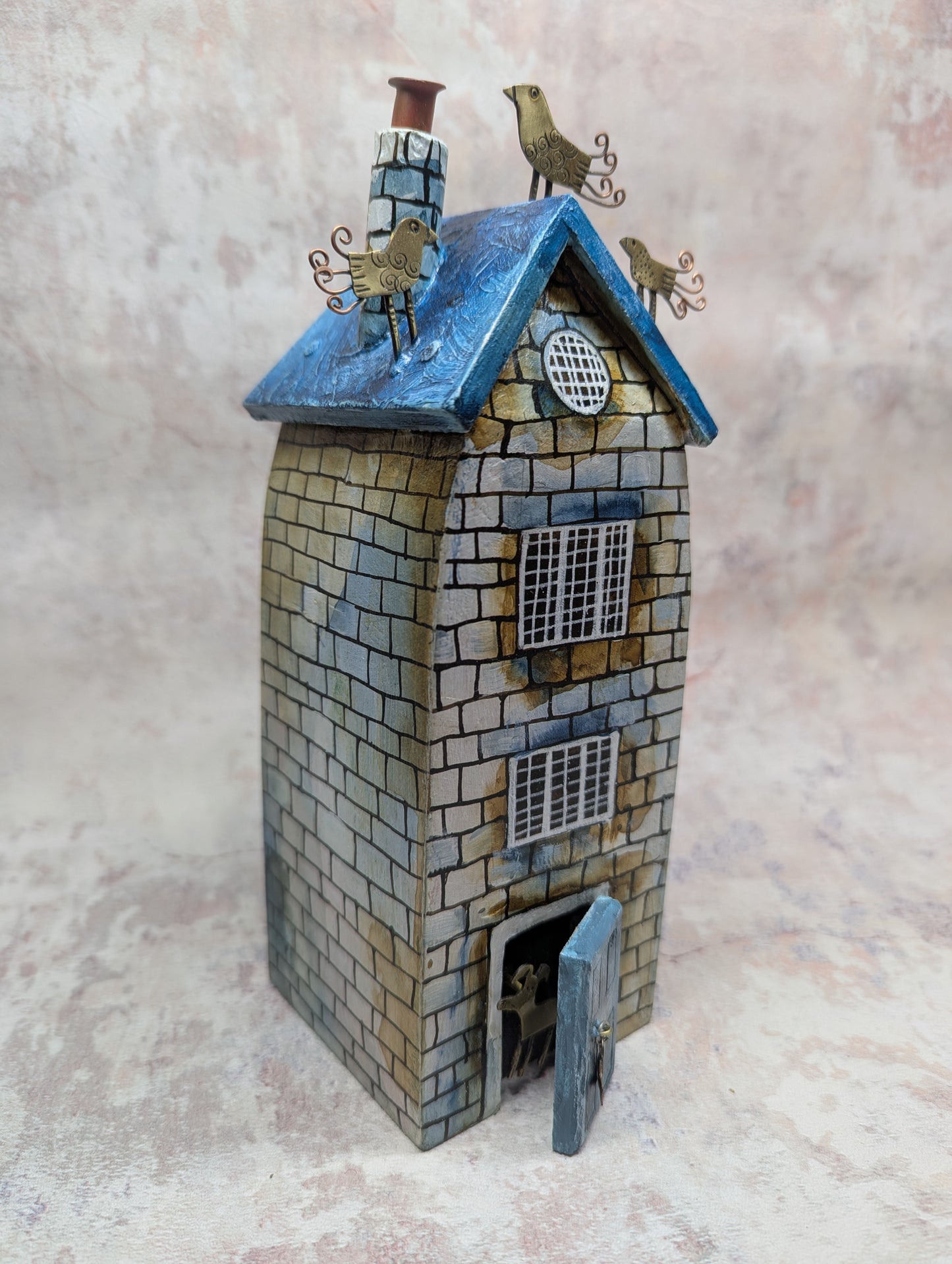 Frances Noon house blue roof with birds blue front door and dog