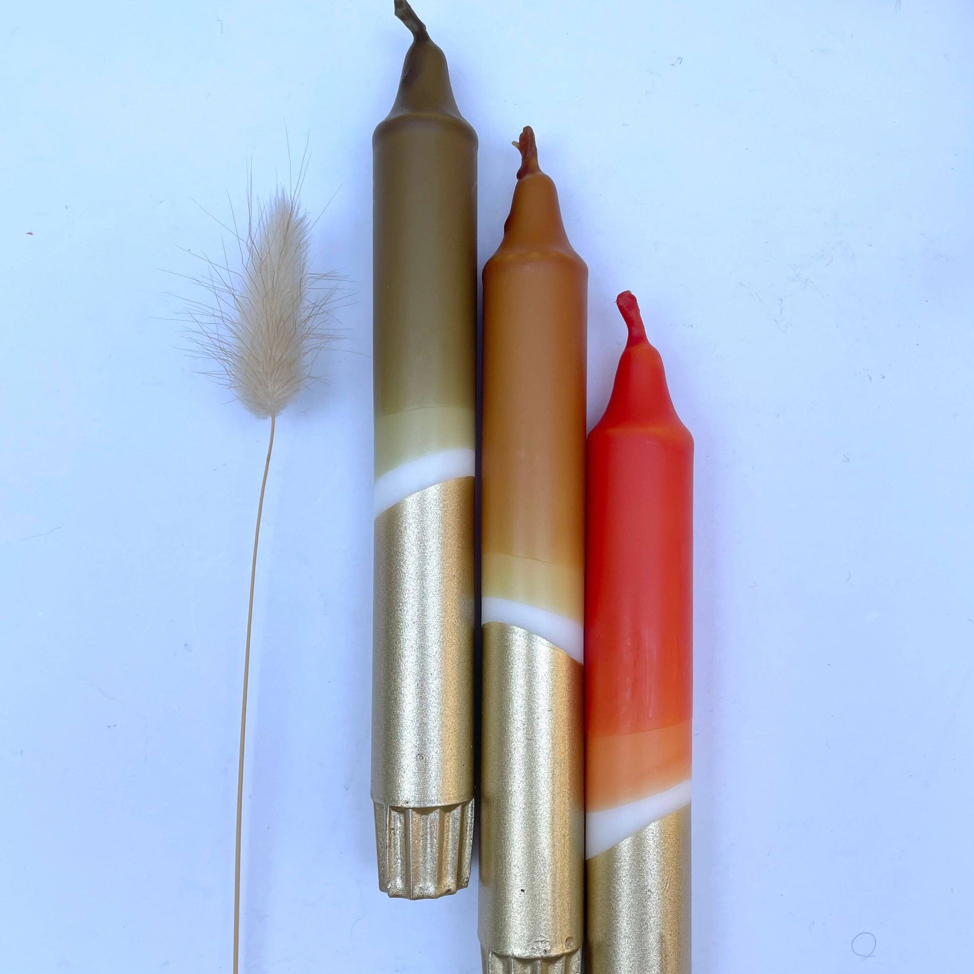 3 hand dip dyed candles by The Singing Rabbit in earthy tones with gold accent