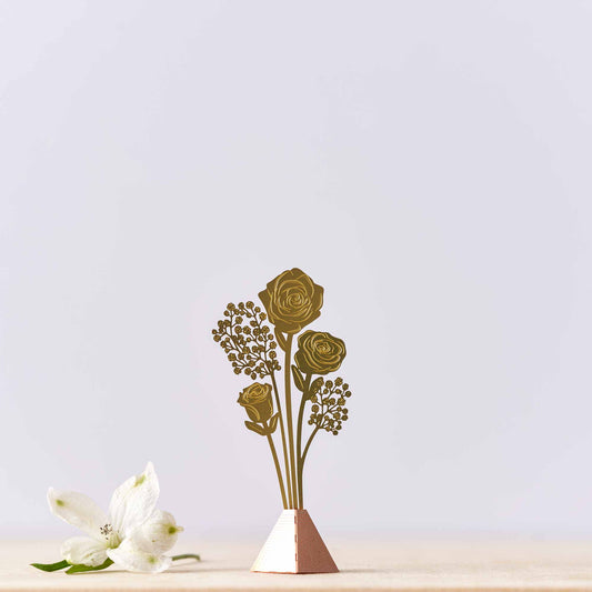 A tiny  bouquet of brass roses in a vase n a blue background, with a 'featured in Gift Shop' label at the bottom.