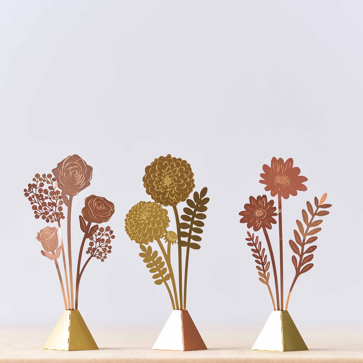 Another Studio tiny bouquet vases of cosmos , roses and dahlia in copper or gold coloured
