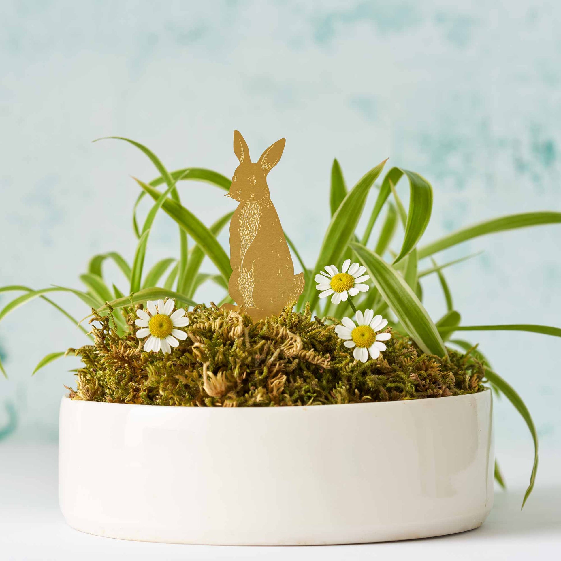 Brass rabbit sitting in a plant pot with moss, and daisies by Another Studio for Heart Gallery 