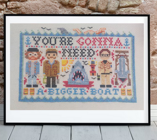 Framed cross-stitched artwork with text and characters by Helen Bretherton for Heart Gallery