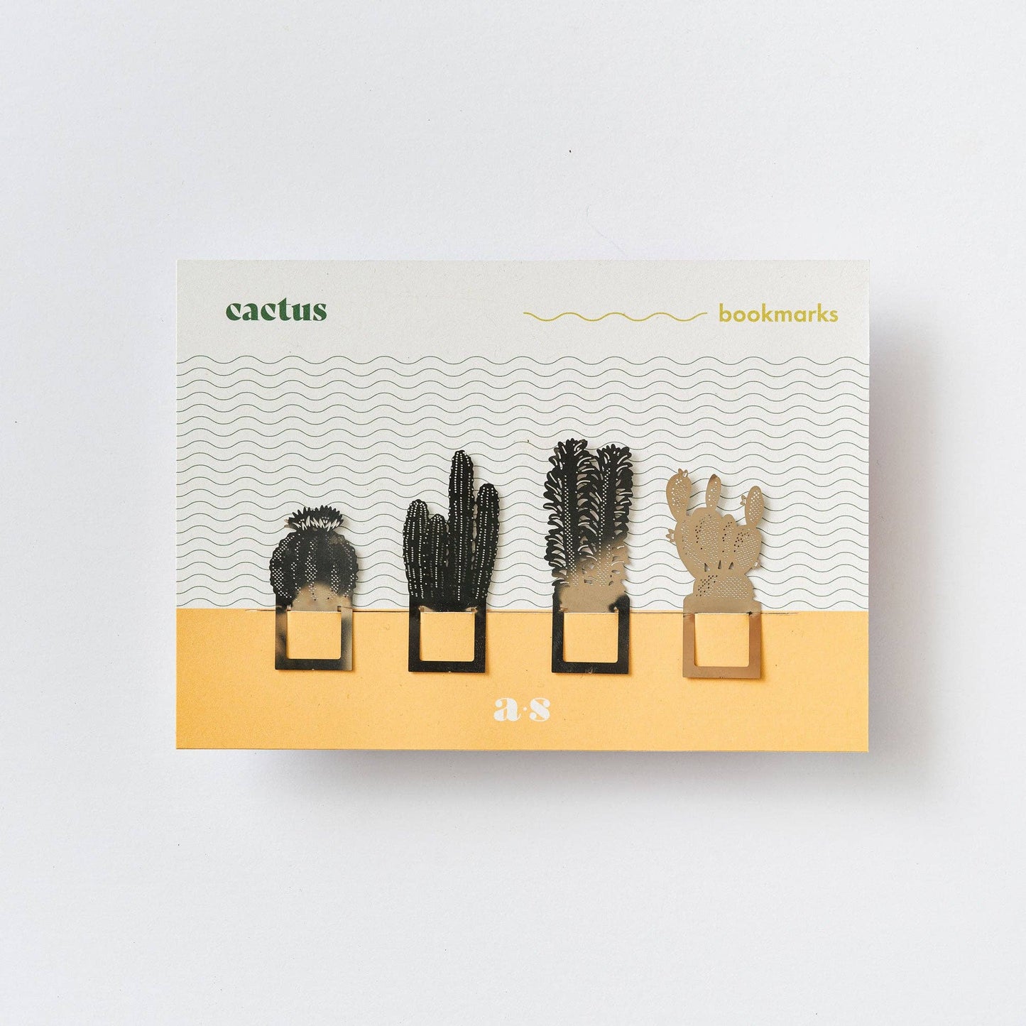 A set of four metal cactus-shaped bookmarks in silver colour, displayed in packaging with a desert-themed design and the brand name 'Another Studio'.