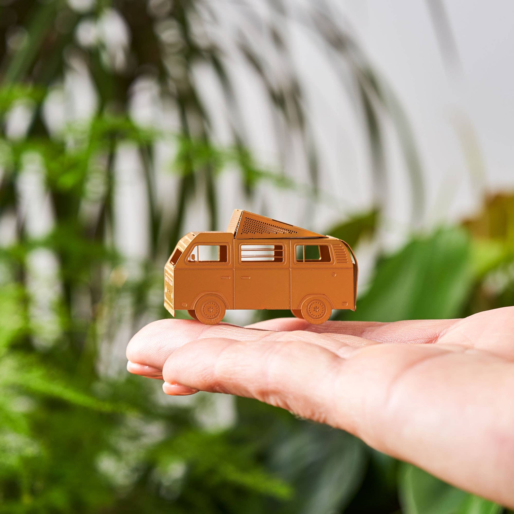  A brass miniature model of a camper van with a pop-top roof, intended for use as a terrarium or plant decoration.