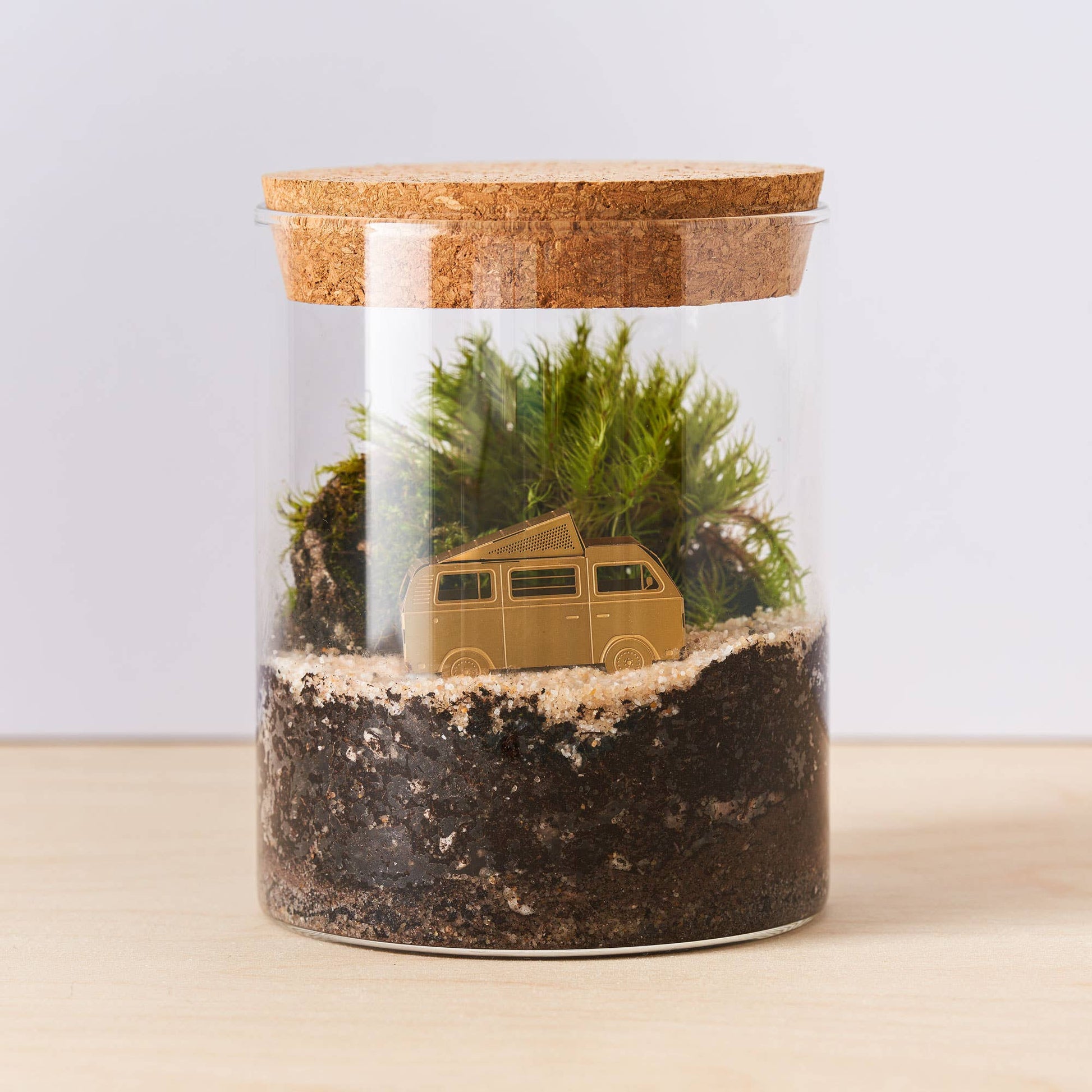  A brass miniature model of a camper van with a pop-top roof, intended for use as a terrarium or plant decoration by Another Studio