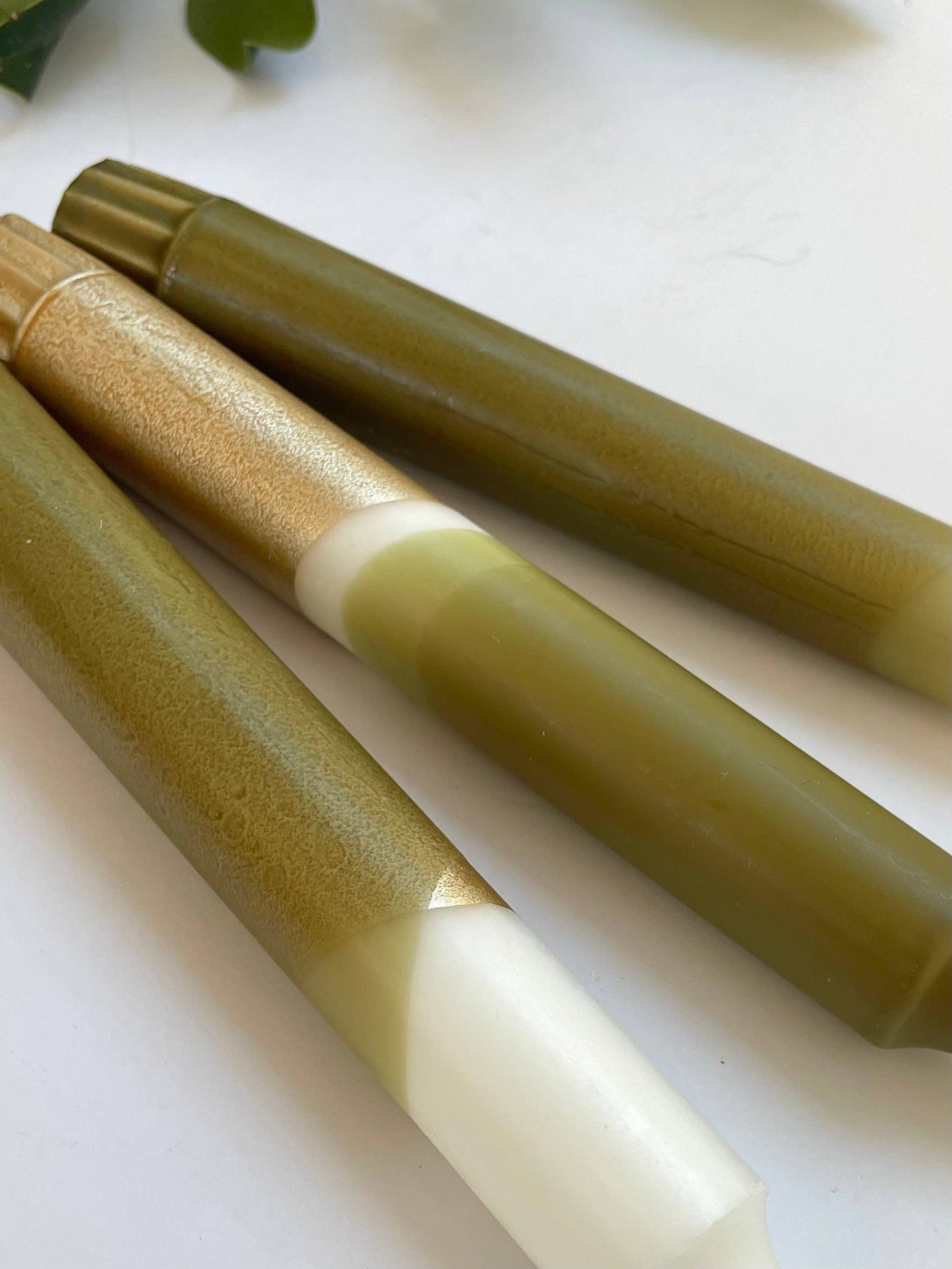 close up of 3 candles by The Singing Rabbit in olive green and gold
