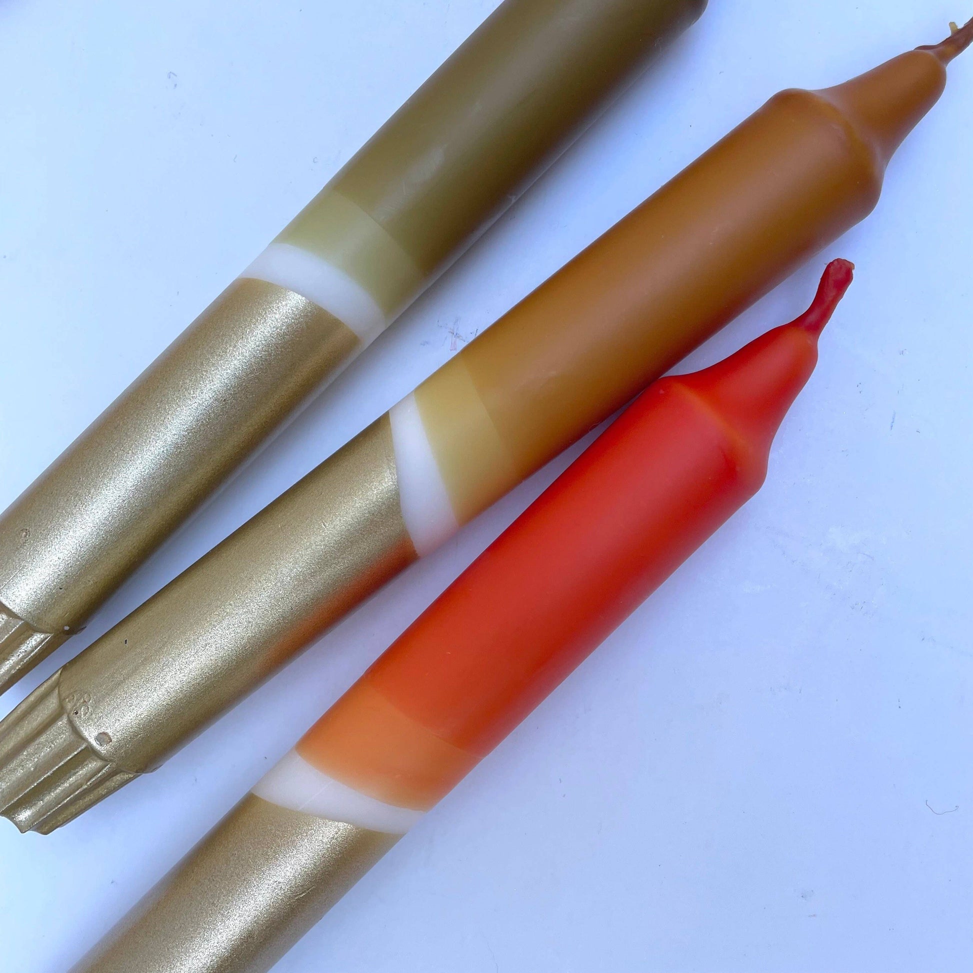 Close up of 3 earth tone candles by The Singing Rabbit
