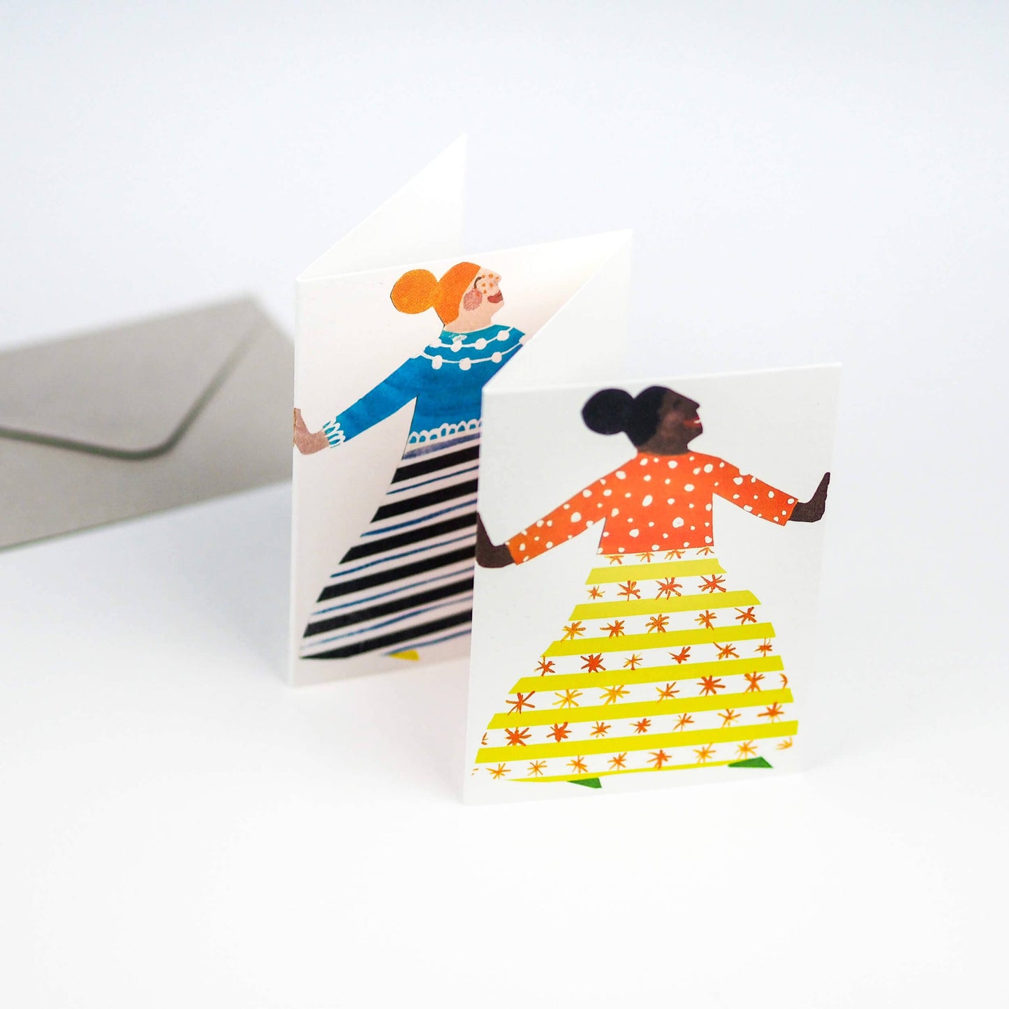 Greeting card with two illustrated women holding hands on a white background