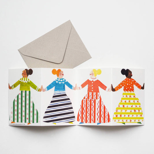 Greeting card with four women holding hands and a beige envelope on a white background