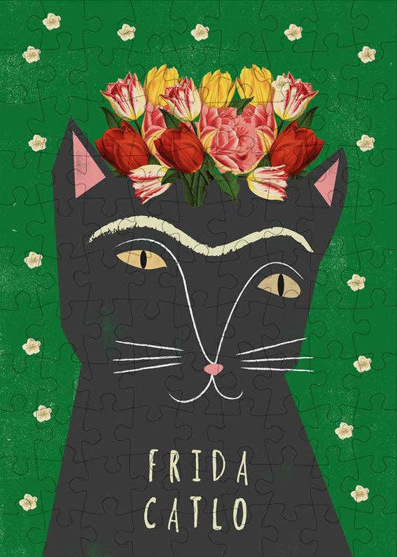 Frida Catlo mini jigsaw puzzle box with a black cat design and floral headband on a green background. 99 pieces