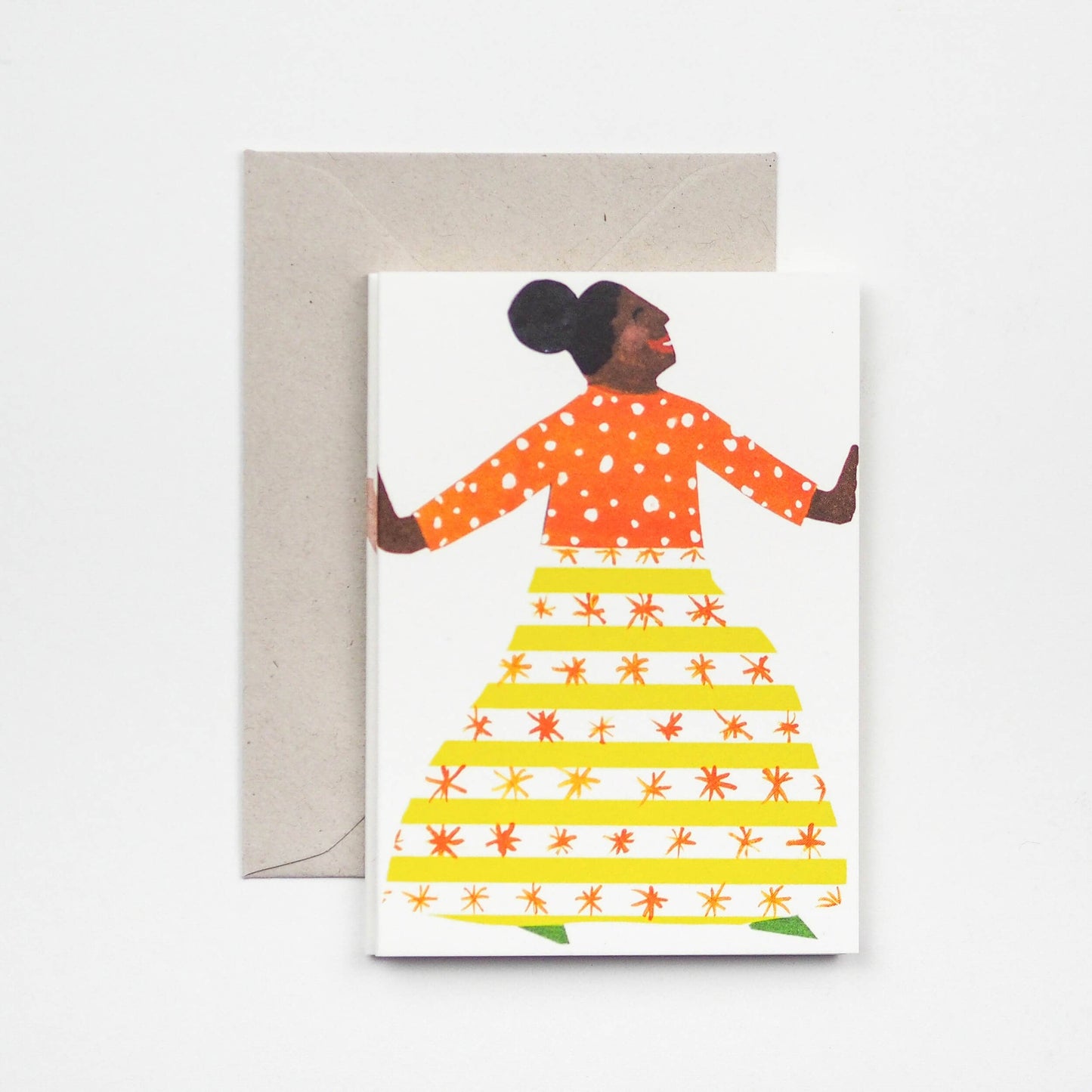 Greeting card with a colorful illustration of a woman wearing an orange top and yellow skirt on a white background.