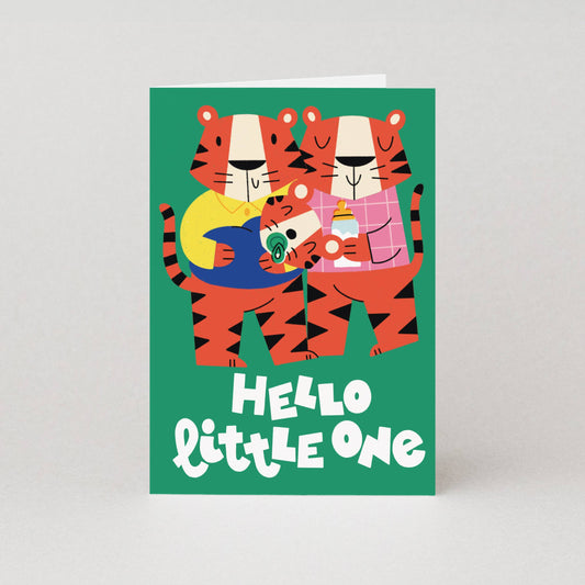 Greeting card with two cartoon tigers holding a baby tiger, text 'Hello little one', on a green background. Gender neutral