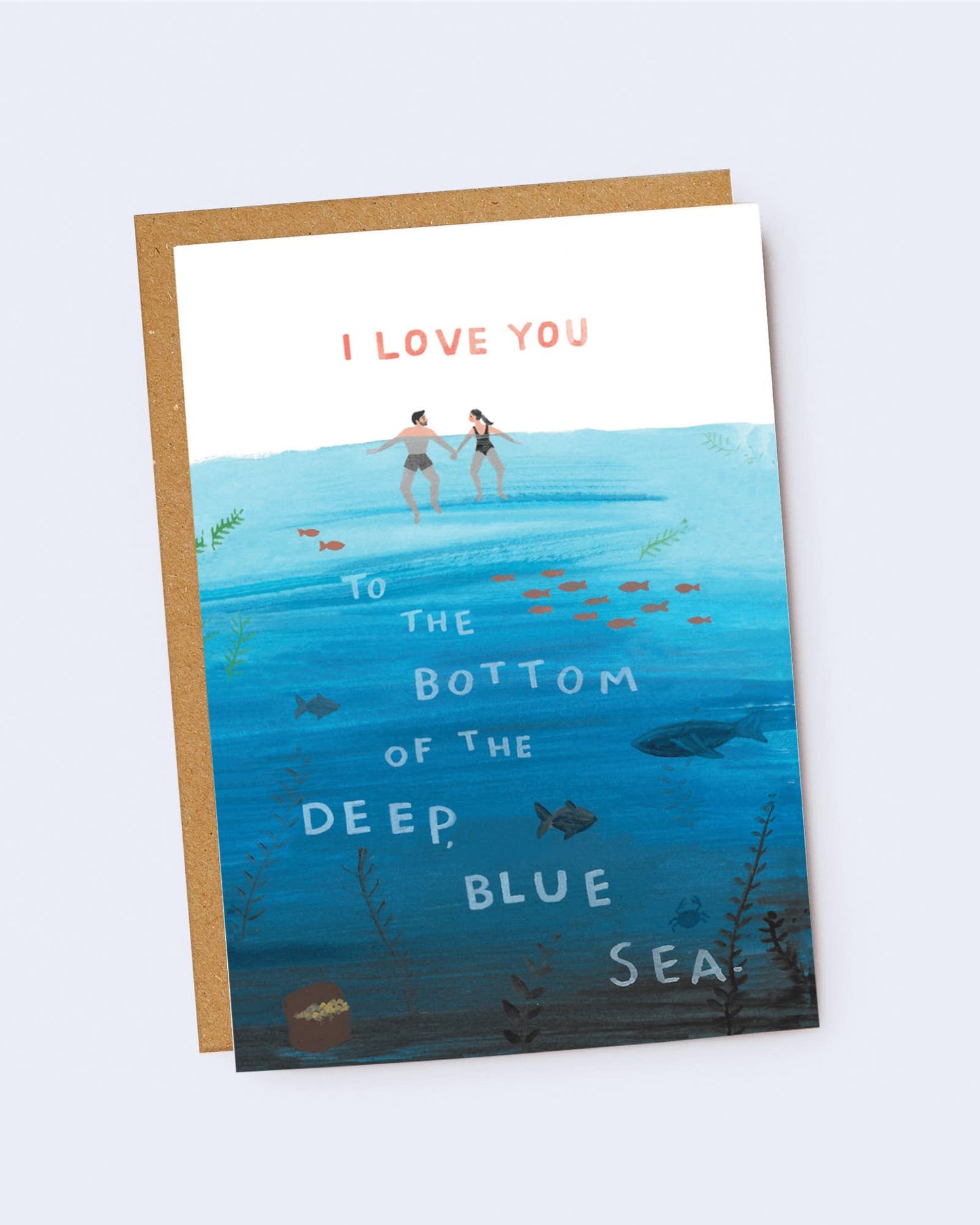Greeting card with illustration of two people in the ocean and text 'I love you to the bottom of the deep blue sea' on a white background. Jade Fisher