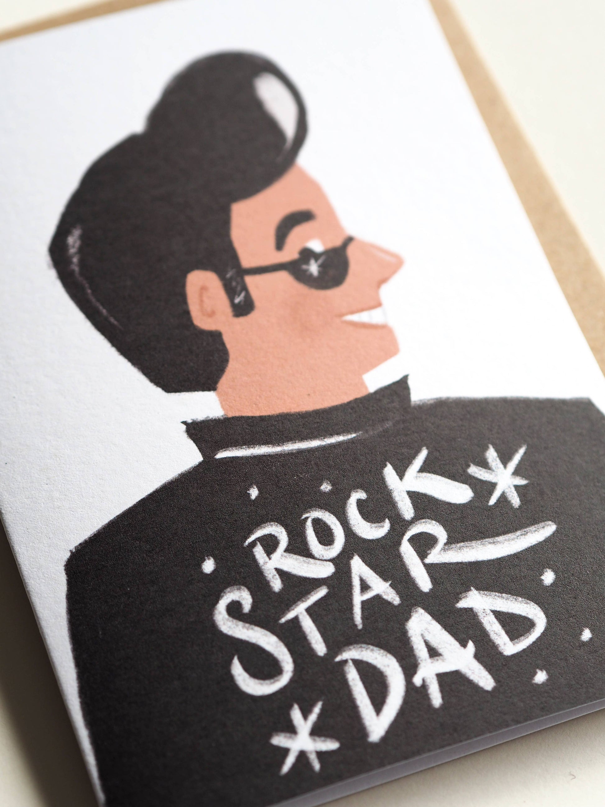 Card with illustration of a man wearing sunglasses and a jacket with 'Rock Star Dad' text.