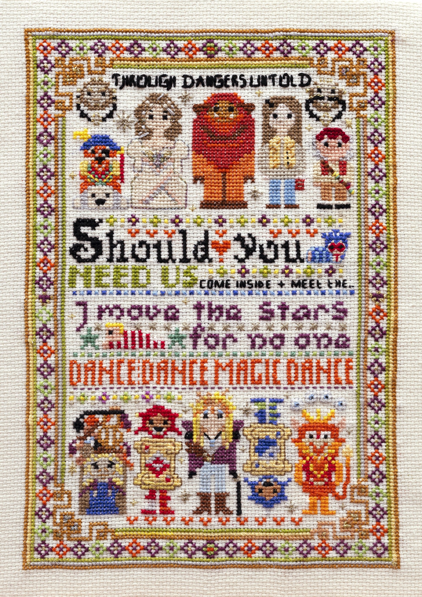 Cross-stitched design with cartoon characters and text on a white background
