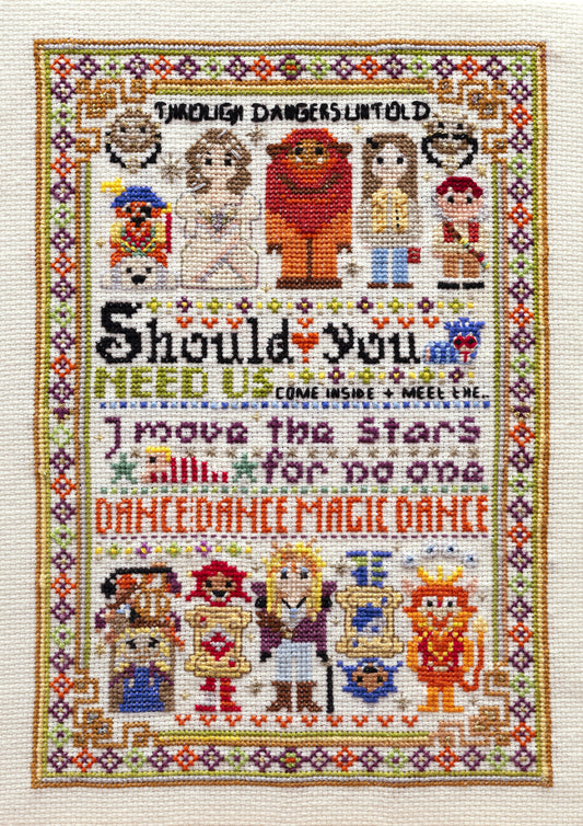 Cross-stitched design with cartoon characters and text on a white background