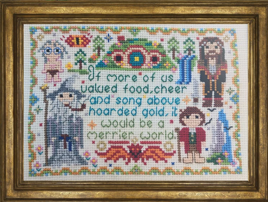 Cross-stitched artwork with characters and text framed in gold