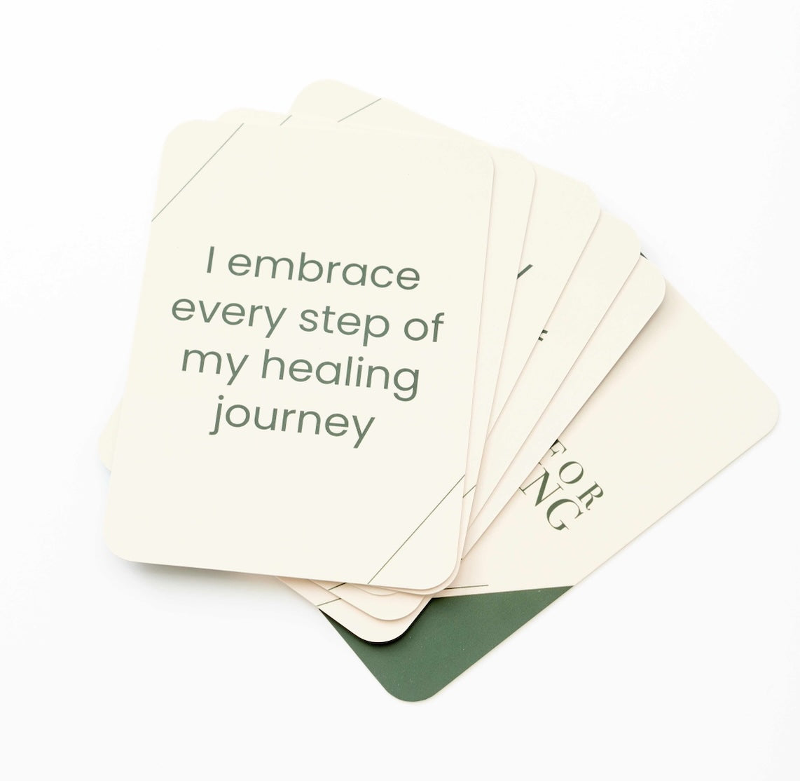 A fan of cream-colored cards with dark green text, fanned out on a clean white background.