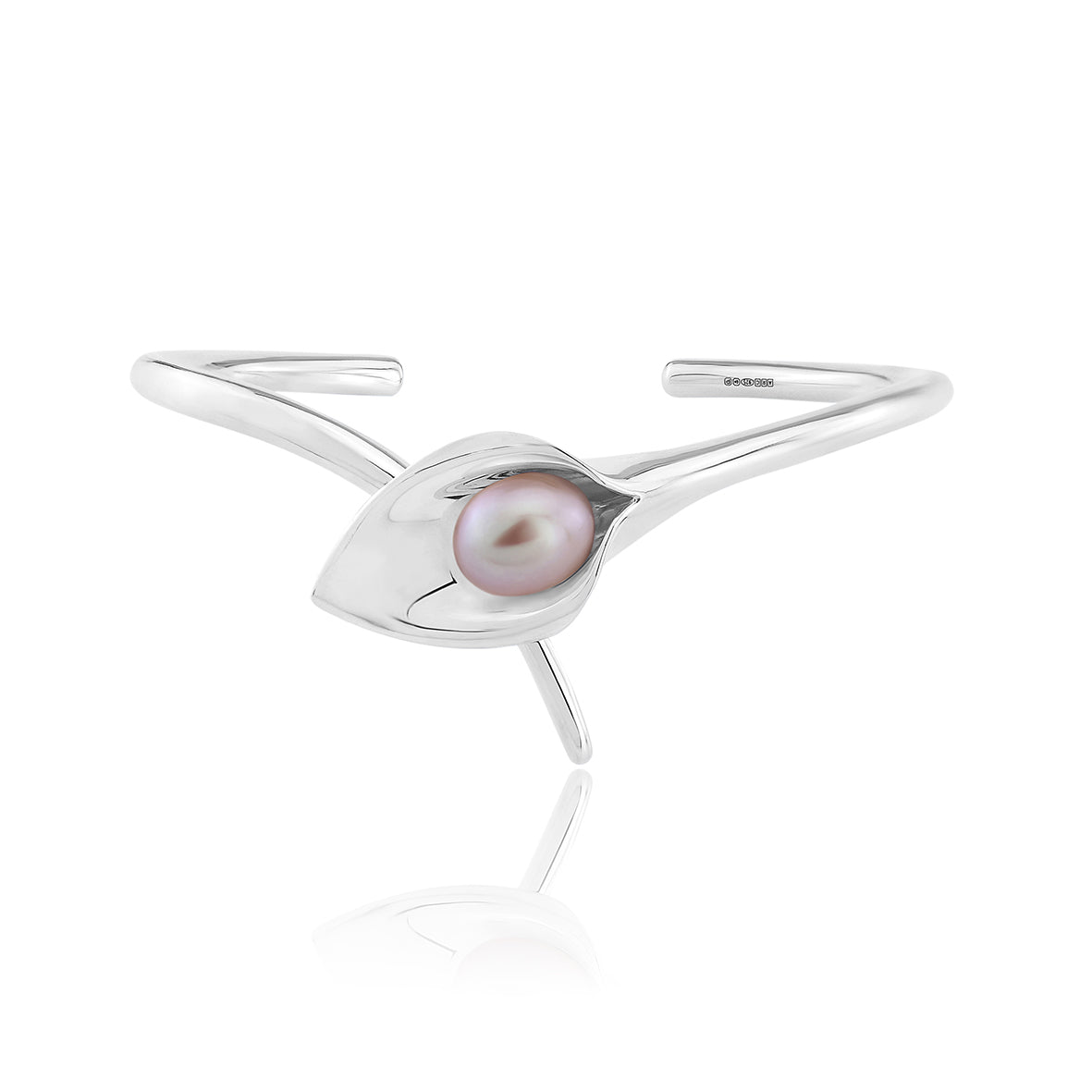 A silver bangle bracelet with a large cultured freshwater pearl, displayed against a white background.Amanda Cox, jewellery handmade in Hebden Bridge Yorkshire for Heart Gallery. Perfect Bridal Jewellery