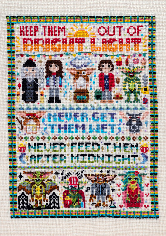 Cross-stitched pattern with characters and text on a white background inspired by dark comedy The Gremlins