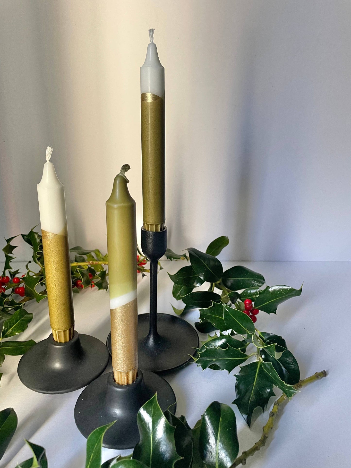 Three hand dip dyed candles by The Singing Rabbit styled in candleholders for Christmas