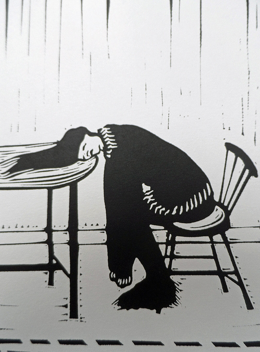 A black and white linocut print of a figure bent over a table, with a chair to the side, created by Polly Marix-Evans.