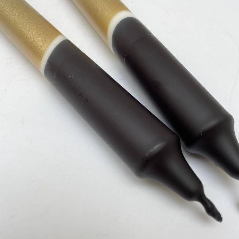 close up of Black and gold hand dip dyed candles by The Singing Rabbit